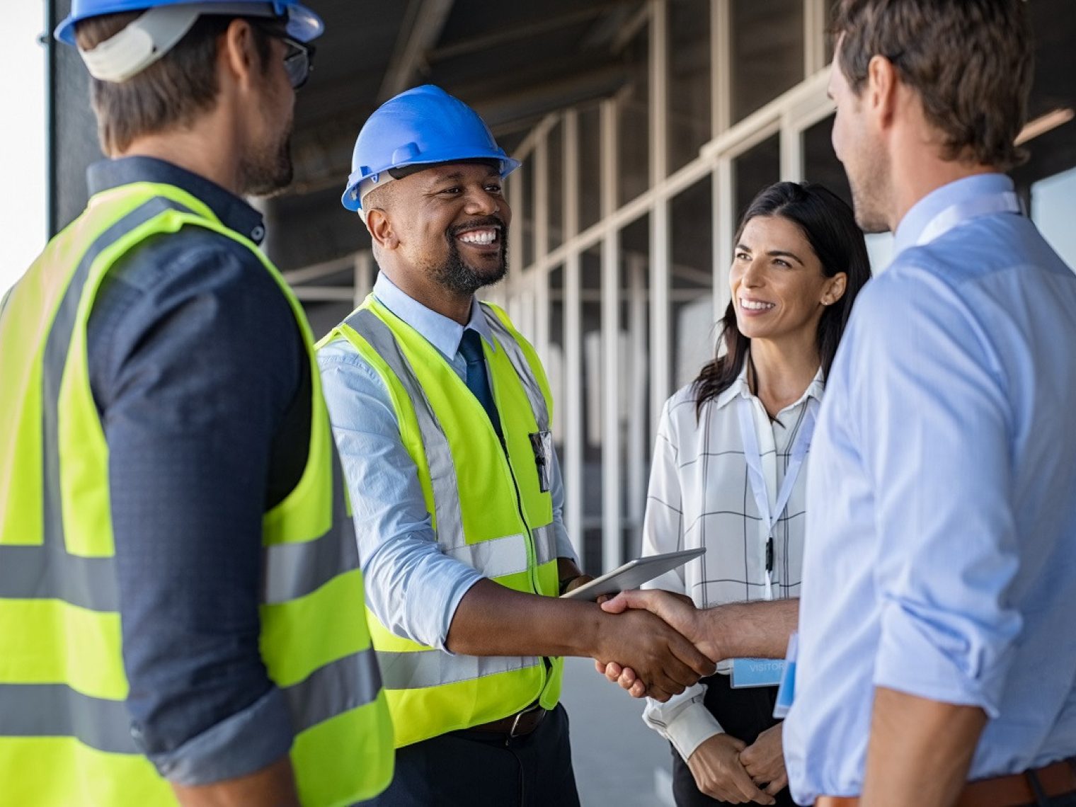 Couple greets contractors on a home construction site.