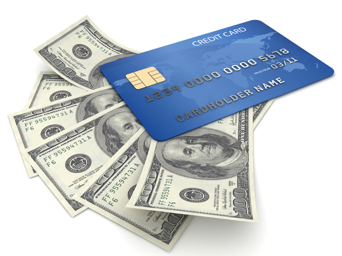 An illustration of a blue credit card resting on top of several one hundred dollar bills.