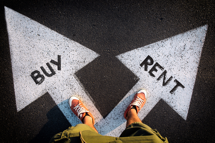 A person standing on a pavement with two diverging arrows pointing in opposite directions, one labeled "BUY" and the other "RENT."