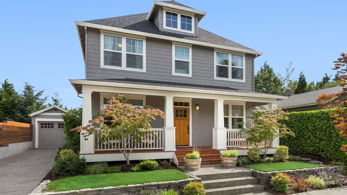 Two story grey house with garage