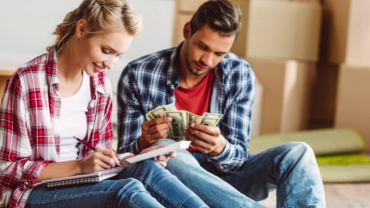 Young couple counting money together.