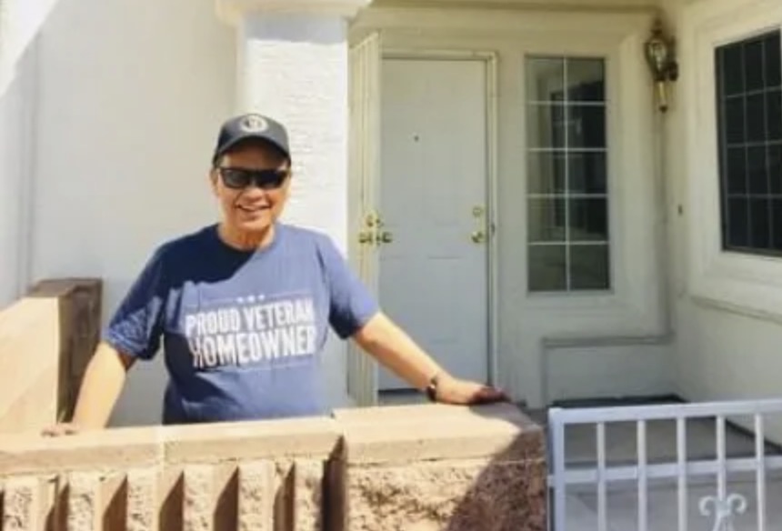 picture of Bayani B. in front of a house