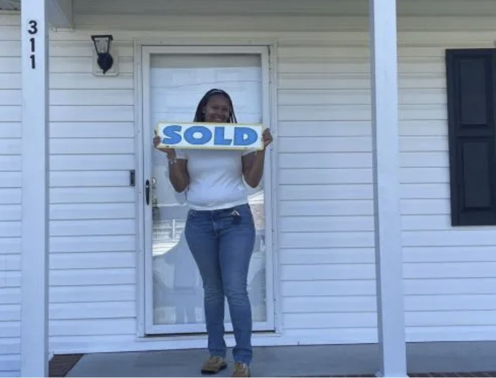 picture of Whitney S. in front of a house